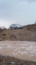 Car parked on puddle