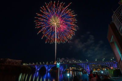 Low angle view of multi-colored firework display at night