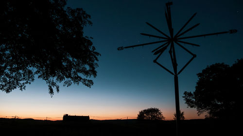 Low angle view of silhouette trees against sky at night