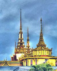 Low angle view of built structure against cloudy sky