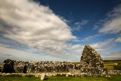 View of old building against cloudy sky