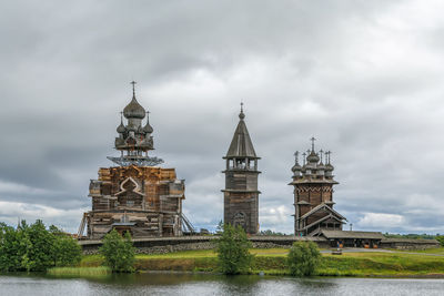 Tower of building against cloudy sky