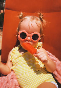 Portrait of smiling woman holding ice cream