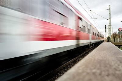 Blurred motion of passenger train at station