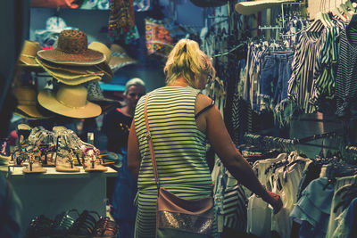 Rear view of woman standing at store