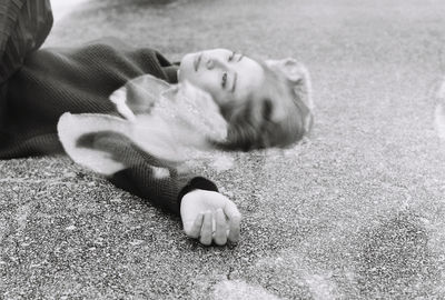 Double exposure of woman lying on floor with flower petal
