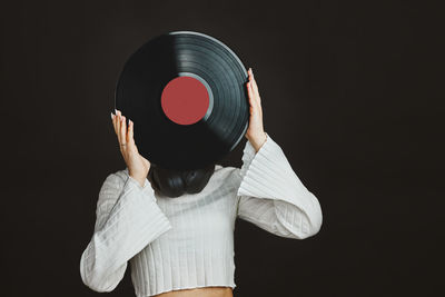 Woman holding vinyl record. music passion. listening to music from analog record. retro music. dj