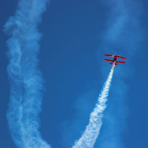 Low angle view of airplane flying in sky