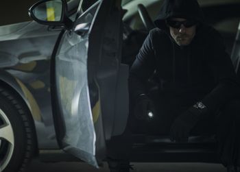 Portrait of burglar sitting in car