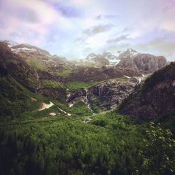 Scenic view of mountains against cloudy sky