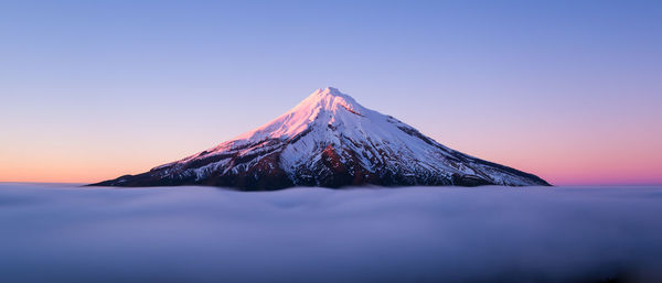 Scenic view of snow covered mountains against clear sky