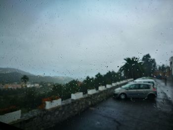 Close-up of wet car window in rainy season