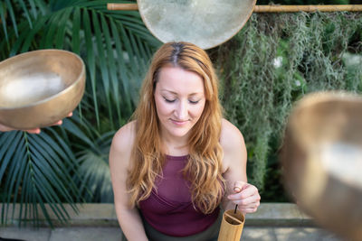 Smiling woman against plants