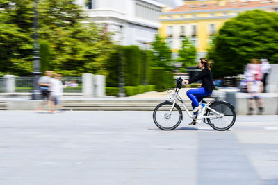 Man riding bicycle in city