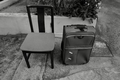 High angle view of empty chairs and table in yard