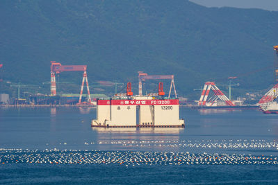 Commercial dock by sea against sky