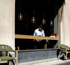 Man sitting on bench in restaurant