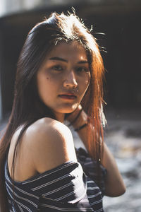 Close-up portrait of young woman standing outdoors