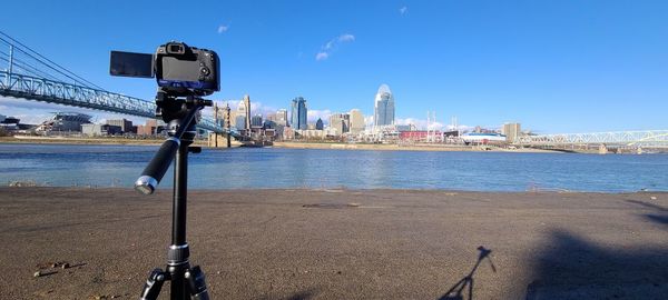 Commercial dock by sea against clear blue sky