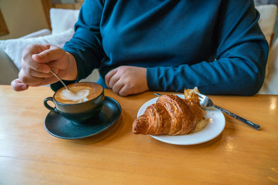 Midsection of man with coffee cup