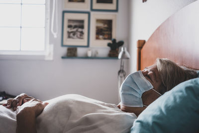 Woman sleeping on bed at home