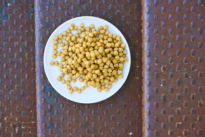 Directly above shot of chickpeas in plate on metal steps