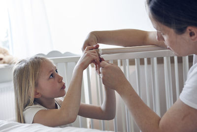 Mother and daughter building cot