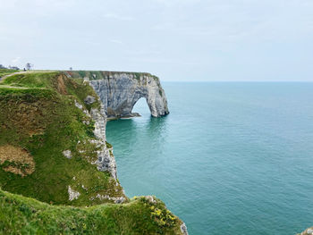 Scenic view of sea against sky and cliffs