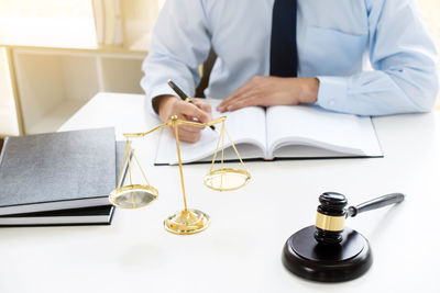 Midsection of man using laptop on table