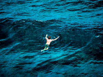 High angle view of man swimming in sea