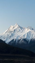 Scenic view of snowcapped mountains against clear sky