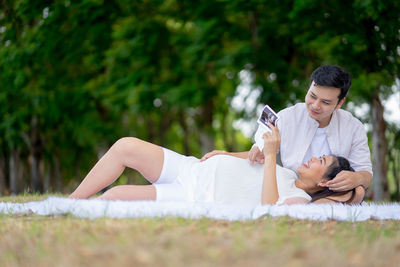 Young couple lying on grass