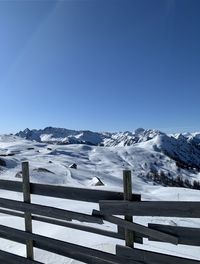 Scenic view of snowcapped mountains against clear blue sky