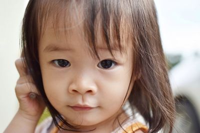 Close-up portrait of cute baby girl at home