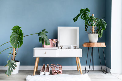 Stylish room interior with elegant dressing table and plants