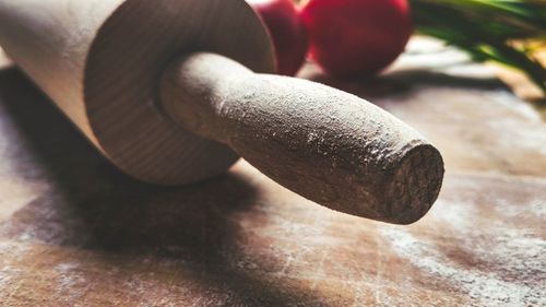 Close-up of rolling pin on wood at home