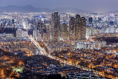 High angle view of illuminated city buildings at night