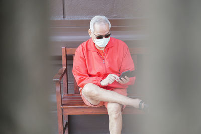 Man looking away while sitting on seat