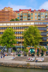 Buildings by street in city against sky