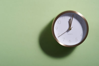 Close-up of clock against wall