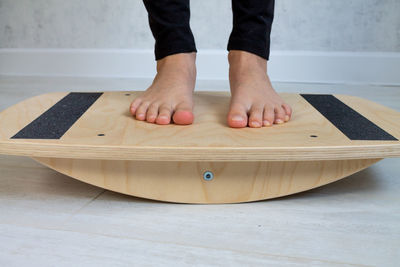 Low section of woman on balance board