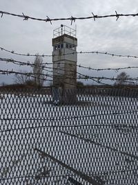 Barbed wire fence against sky