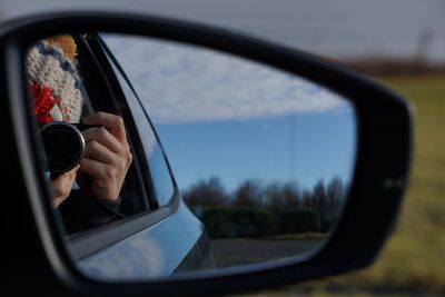 Reflection of photographer in rear view mirror