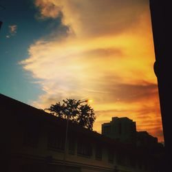 Low angle view of silhouette buildings against sky