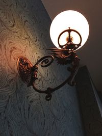 Low angle view of illuminated electric lamp