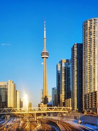 The moon behind sunny cn tower