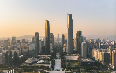 Buildings in city against sky during sunset