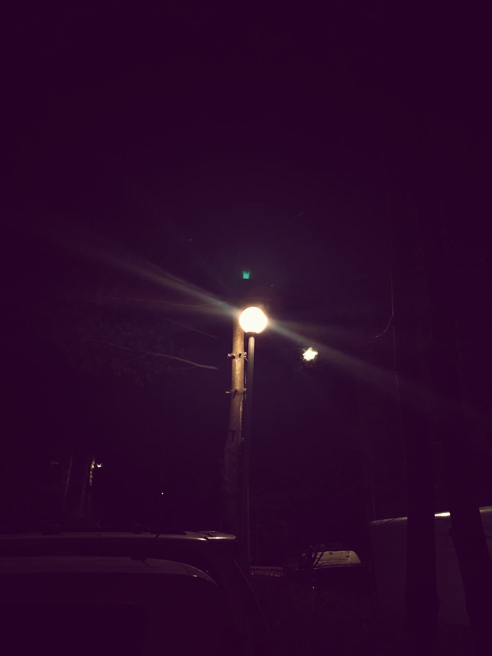 ILLUMINATED STREET LIGHT AGAINST NIGHT