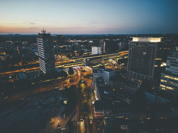 Aerial view of buildings in essen under sky at dusk