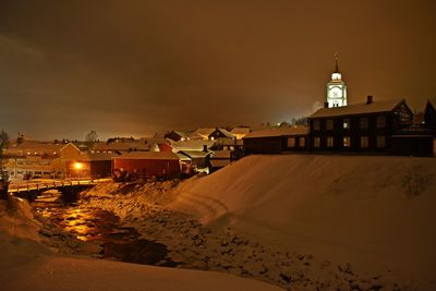 Houses in city at night during winter